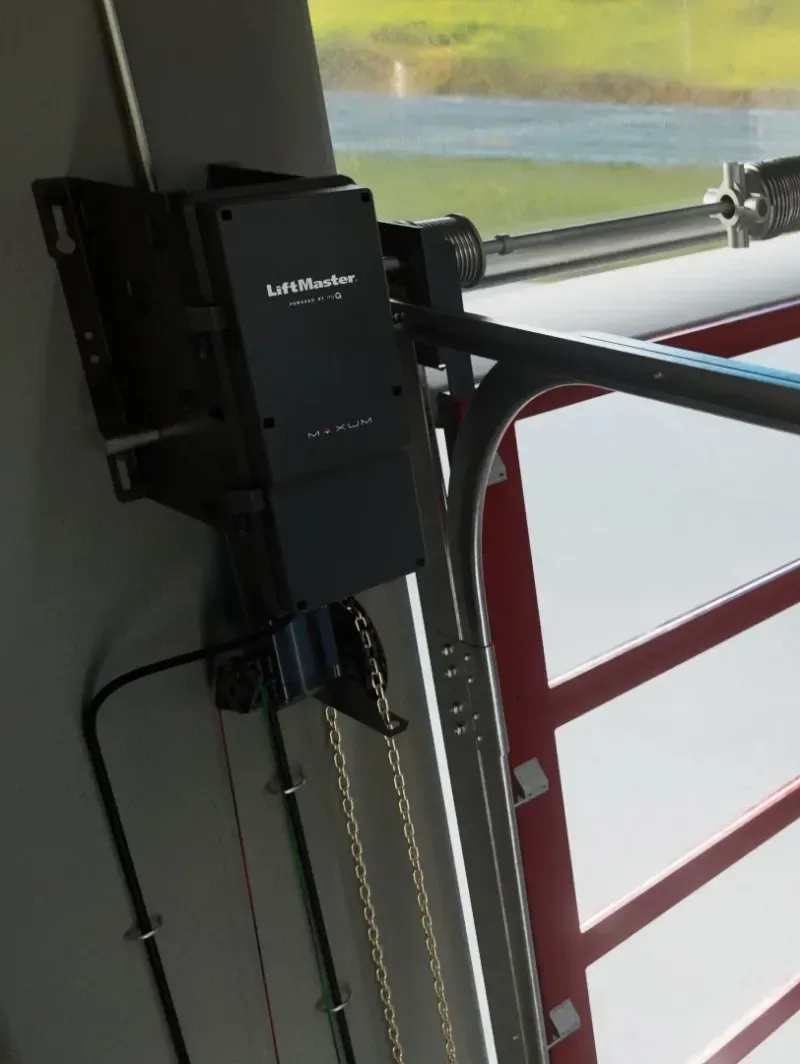 Closeup of a liftmaster overhead garage door opener on a repair shop door
